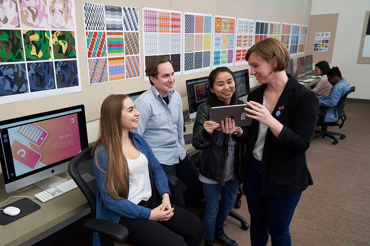 students in graphic design lab with professor